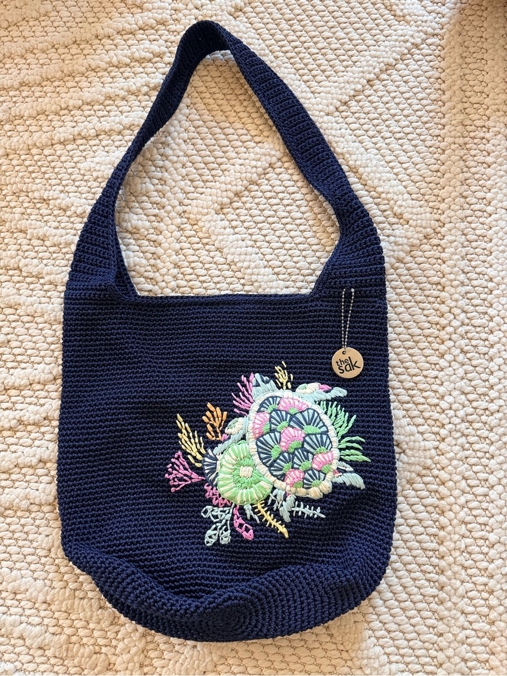 The Sak Navy Crochet Shoulder Bag with Pastel Embroidered turtle